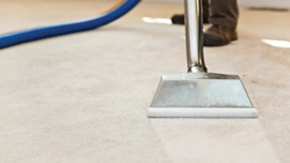 Carpet cleaning wand head gliding over a light carpet during hot-water extraction, Nashville, TN.